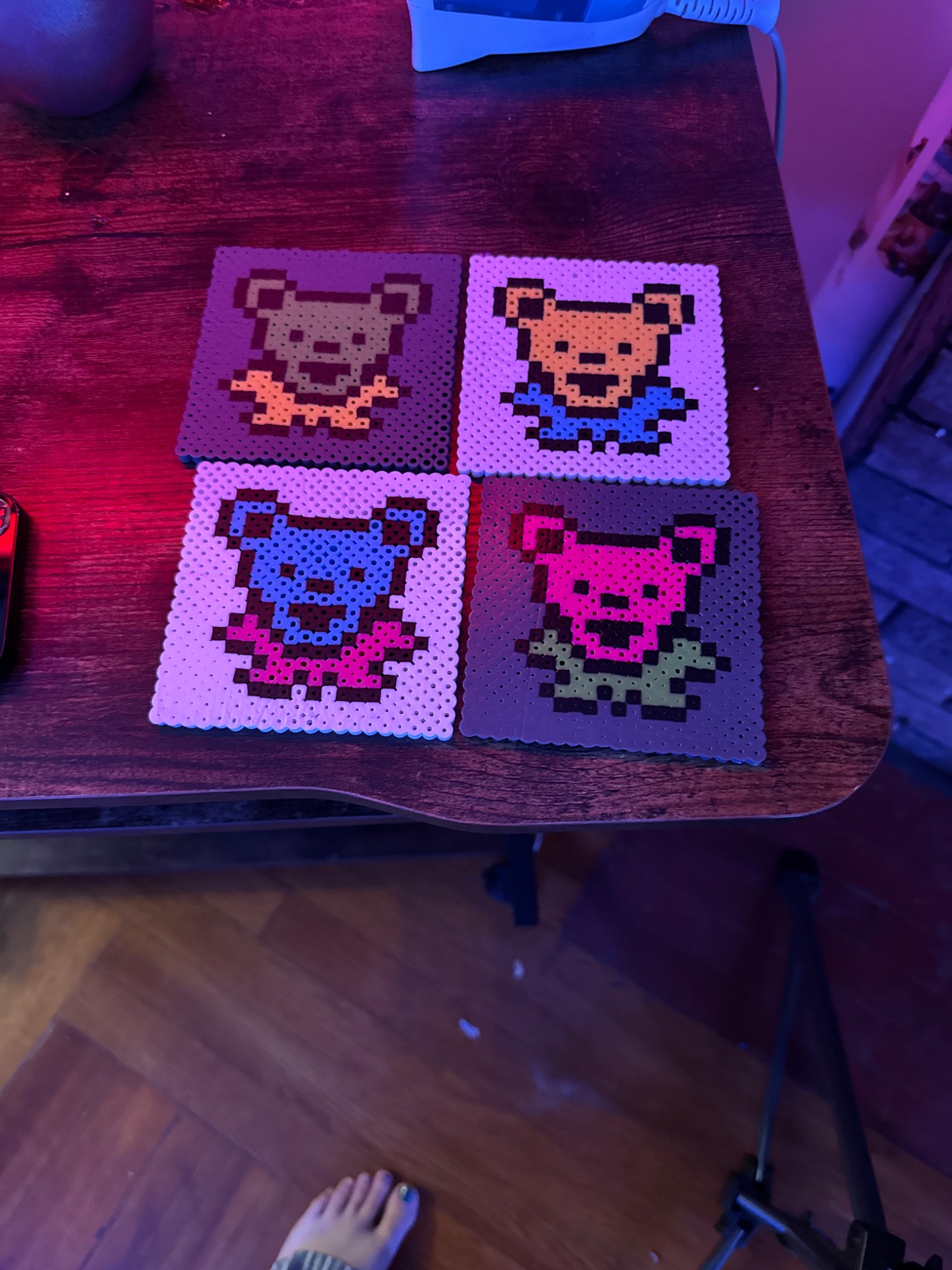 Four colorful dancing-bear fusion-bead designs created by Matt
